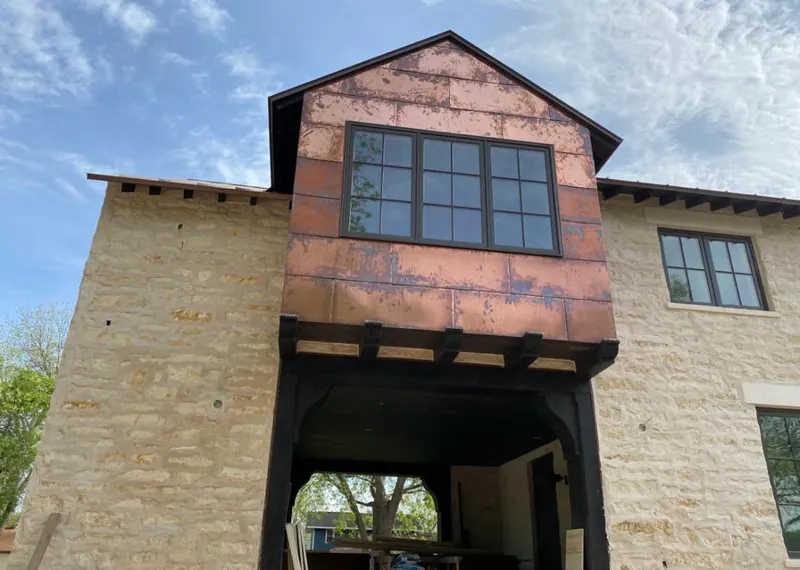 Copper metal panel facade on a stone building for Roof Repair in Riverside